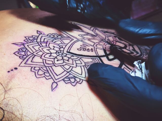 Ornamental mandala stencil applied to skin